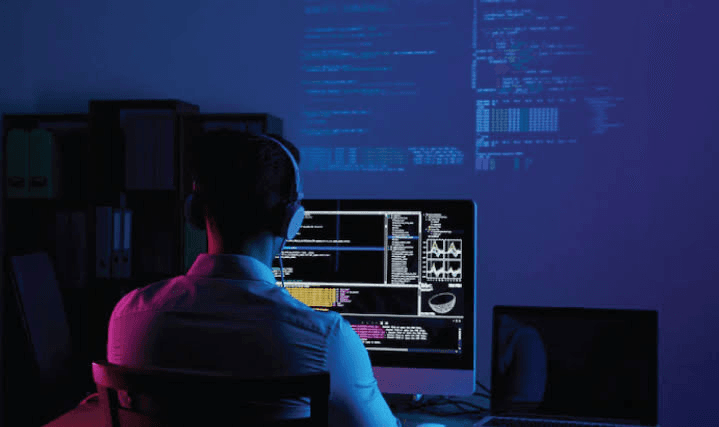 A developer writing code, illustrating the fragmented nature of large-system work